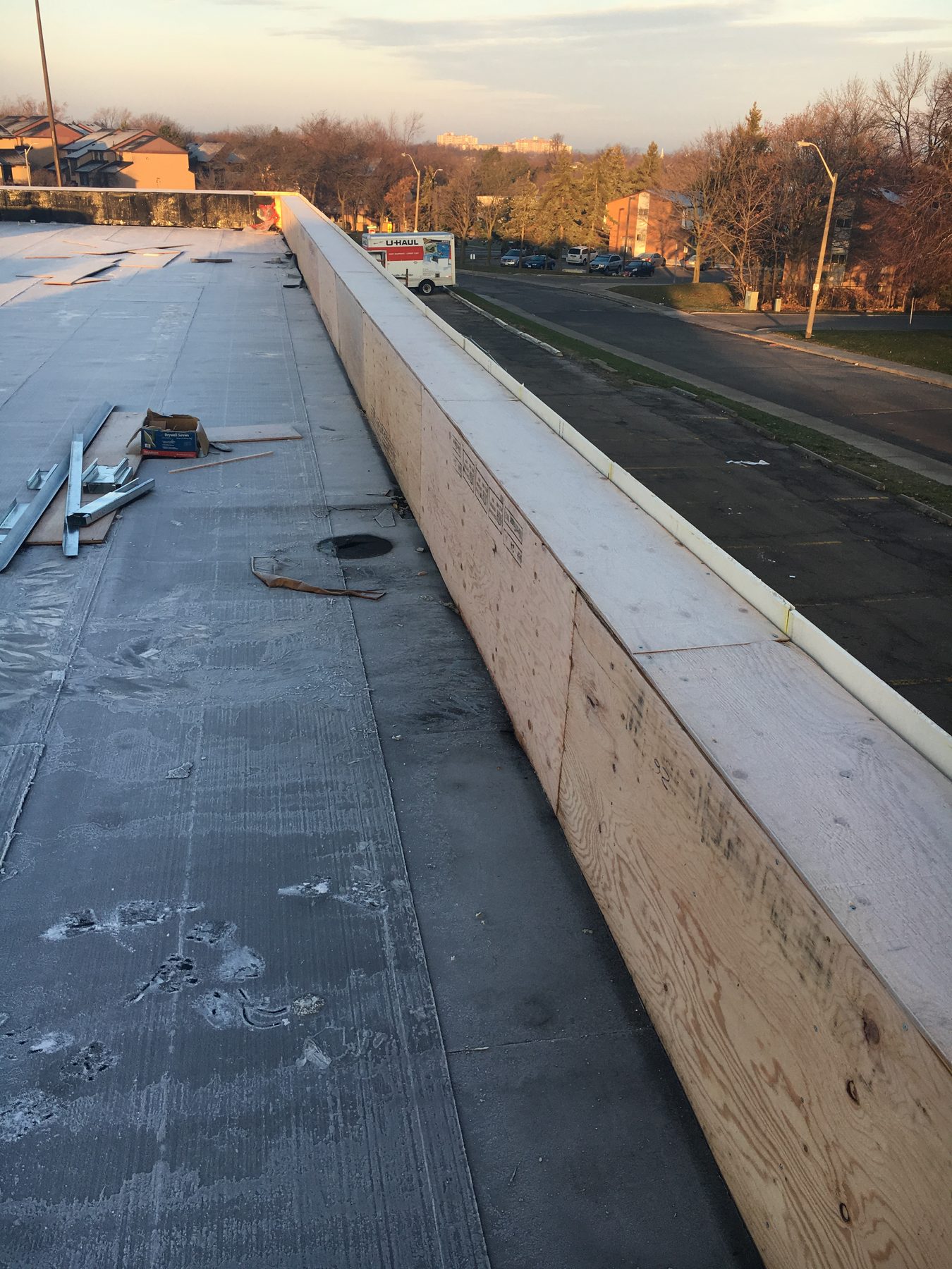 Parapet and low-slope roofing work on a commercial property